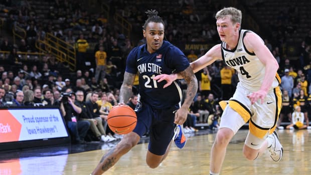 Penn State's RayQuawndis Mitchell drives to the basket against the Iowa Hawkeyes in a Big Ten men's basketball game.